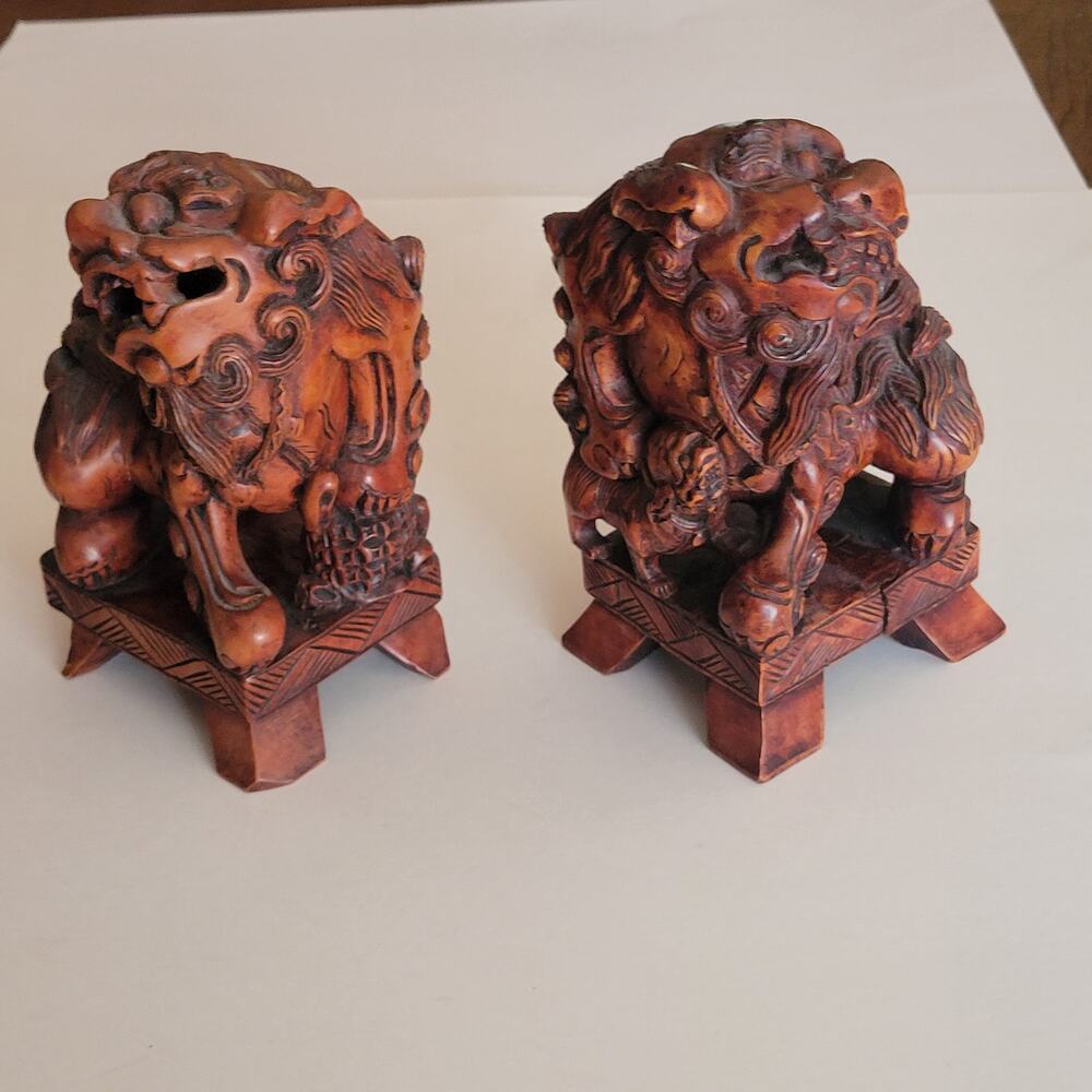 Vintage hand-carved wooden sculptures of pair of Chinese Foo dogs